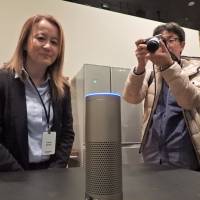 Karen Rubin, Amazon Japan senior manager overseeing the Alexa AI voice agent, demonstrates Amazon\'s Echo Plus smart speaker in Tokyo on Wednesday. | KAZUAKI NAGATA