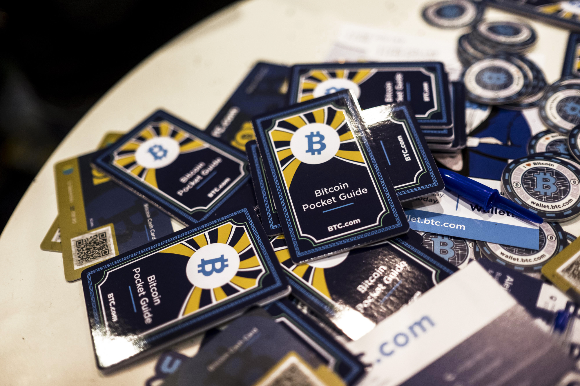 Free bitcoin pocket information guides sit on a table at the BTC.com marketing stand at the Lisbon Web Summit in Lisbon, Portugal, on Tuesday. | BLOOMBERG