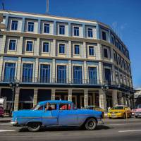 A car passes by the Telegrafo Hotel in Havana on Wednesday. Tighter restrictions on U.S. travelers to Cuba will go into effect on Thursday, officials said, almost five months after President Donald Trump vowed to crack down. | AFP-JIJI