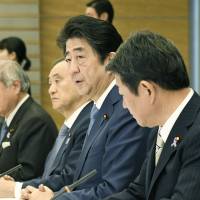Prime Minister Shinzo Abe addresses ministers at the Prime Minister\'s Office on Friday. | KYODO