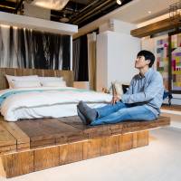 Yanolja CEO Lee Su-jin poses in a mock-up motel room at the company\'s headquarters in Seoul on Oct. 10. | BLOOMBERG