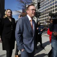 Mick Mulvaney leaves the Consumer Financial Protection Bureau in Washington Monday. | AP