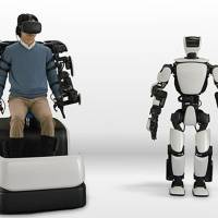 Toyota Motor Corp.\'s T-HR3 is controlled from a Master Maneuvering System that allows the entire body of the robot to be operated through wearable controls. | TOYOTA MOTOR CORP.