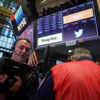 Traders work at the post where Snap and Twitter are traded on the floor of the New York Stock Exchange (NYSE) in New York Thursday. | REUTERS