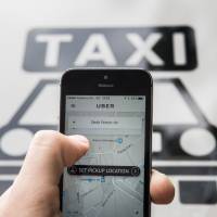 SoftBank Group Corp. and a group of investors are reportedly trying to buy a big stake in Uber Technologies Inc. at a steep discount. | BLOOMBERG