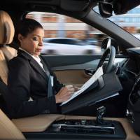 This file handout picture provided by Swedish carmaker Volvo taken in 2016 shows a woman reading inside a so-called autonomous driving (AD) car. Swedish carmaker Volvo Cars said Monday it has signed an agreement to supply \"tens of thousands\" of self-driving cars to the ride-sharing company Uber, which has been hit by a series of controversies. | VOLVO / HANDOUT / VIA AFP-JIJI
