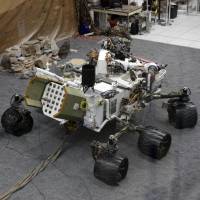 Engineers work on a model of the Mars rover Curiosity at the Spacecraft Assembly Facility at NASA\'s Jet Propulsion Laboratory in Pasadena, California, in August 2012. | AP