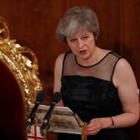 British Prime Minister Theresa May makes a speech at the Lord Mayor\'s Banquet at the Guildhall in London\'s financial district on Monday. Beside her is the lord mayor of the City of London, Charles Bowman. | REUTERS