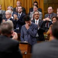 Canadian Prime Minister Justin Trudeau wipes away tears while delivering an apology to members of the LGBT community who were discriminated against by federal legislation and policies, in the House of Commons on Parliament Hill in Ottawa Tuesday. | REUTERS