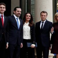 French President Emmanuel Macron and his wife, Brigitte Macron (right), stand with Lebanese Prime Minister Saad Hariri and his wife, Lara Hariri, and their elder son, Hussam, at the Elysee Palace in Paris on Saturday. | REUTERS