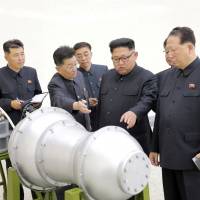 North Korean leader Kim Jong Un provides guidance with Ri Hong Sop (second from left) and Hong Sung Mu (right) on the country\'s nuclear weapons program in this undated photo released on Sept. 3. | KCNA / VIA REUTERS