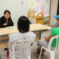 Pregnant domestic workers speak with social worker Jessica Chow at PathFinders in Tai Kok Tsui, Hong Kong, on Oct. 30. | THOMSON REUTERS FOUNDATION