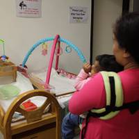 Indonesian domestic worker Anisa and her 1-year-old daughter are seen on Oct. 30 at PathFinders in Hong Kong. | THOMSON REUTERS FOUNDATION