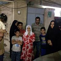 People stand in the street after feeling aftershocks from an earthquake in Baghdad Sunday. The deadly earthquake hit the region along the border between Iran and Iraq on Sunday. | AP