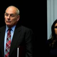 White House Chief of Staff John Kelly and White House spokeswoman Sarah Sanders listen as U.S. President Donald Trump hosts a tax reform industry meeting at the White House in Washington Tuesday. | REUTERS