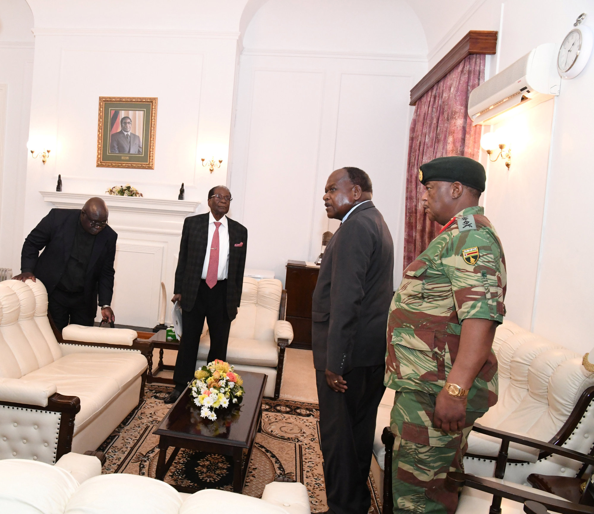 Zimbabwe President Robert Mugabe (second from left) meets with Father Fidelis Mukonori, Secretary to the Cabinet Dr. Misheck Sibanda and defense forces commander Gen. Constantino Chiwenga at State House in Harare on Nov. 19. | REUTERS