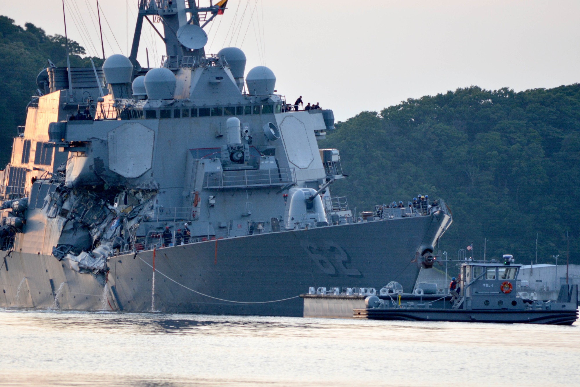 The guided-missile destroyer USS Fitzgerald returns to port in Yokosuka, Kanagawa Prefecture, following a June collision with a merchant vessel while operating southwest of Tokyo Bay. | U.S. NAVY