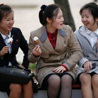 North Korean girls enjoy ice cream at a zoo in Pyongyang in April. | REUTERS