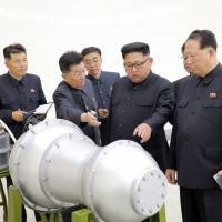 North Korean leader Kim Jong Un visits a nuclear weapons site in this undated photo released Sept 3. The country\'s state-run media said Kim had inspected the loading of a hydrogen bomb onto a new intercontinental ballistic missile, a claim that could not be independently verified. An apparent diagram of how the supposed bomb would fit onto the tip of the long-range missile is displayed in the background. | AP