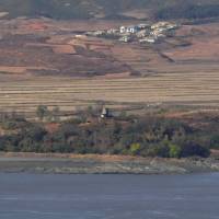 A North Korean guard post (center) in the border county of Kaepoong is seen from a South Korean observation post in Paju near the Demilitarized Zone (DMZ) dividing the two Koreas on Nov. 14. | AFP-JIJI