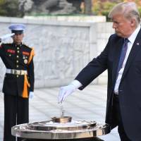 U.S. President Donald Trump burns incense at the National Cemetery in Seoul on Wednesday. Trump offered North Korean leader Kim Jong Un what he called \"a path towards a much better future\" as tensions soar over Pyongyang\'s nuclear ambitions. | AFP-JIJI