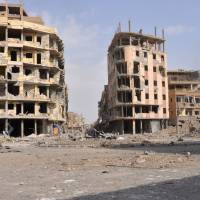 A general view shows damaged buildings in the eastern Syrian city of Deir Ezzor, Syria, on Saturday. Syrian and allied forces converged on holdout Islamic State group fighters in the Syrian border town of Albu Kamal, the jihadis\' very last urban bastion following a string of losses. | AFP-JIJI