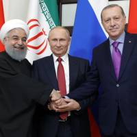 Russian President Vladimir Putin, Turkish President Recep Tayyip Erdogan and Iranian President Hassan Rouhani are seen in Sochi on Wednesday while attending a trilateral meeting on Syria. | AFP-JIJI