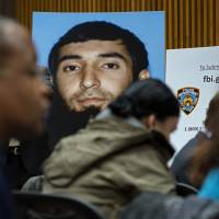 A photo of Sayfullo Saipov is displayed at a news conference at One Police Plaza on Wednesday. | AP