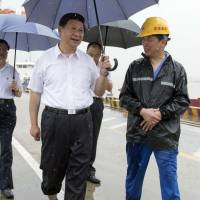 Chinese President Xi Jinping inspects the Yangluo container port in Wuhan, Hubei province, in July 2013. | AP