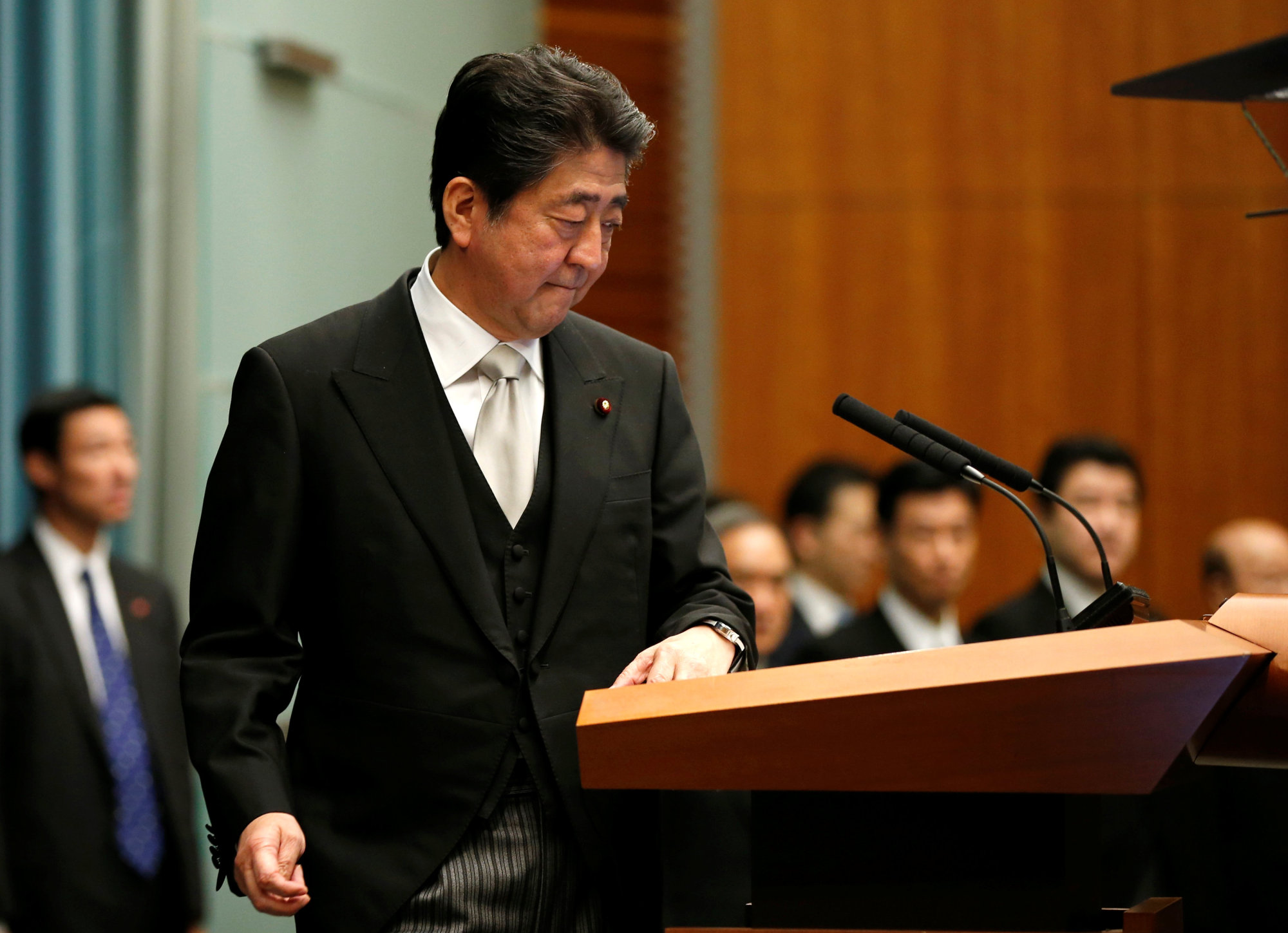 Prime Minister Shinzo Abe arrives at a news conference at the Prime Minister's Office in Tokyo on Wednesday. | REUTERS