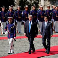 U.S. President Donald Trump and Prime Minister Shinzo Abe take part in a welcoming ceremony at Akasaka Palace in Tokyo on Monday. | REUTERS