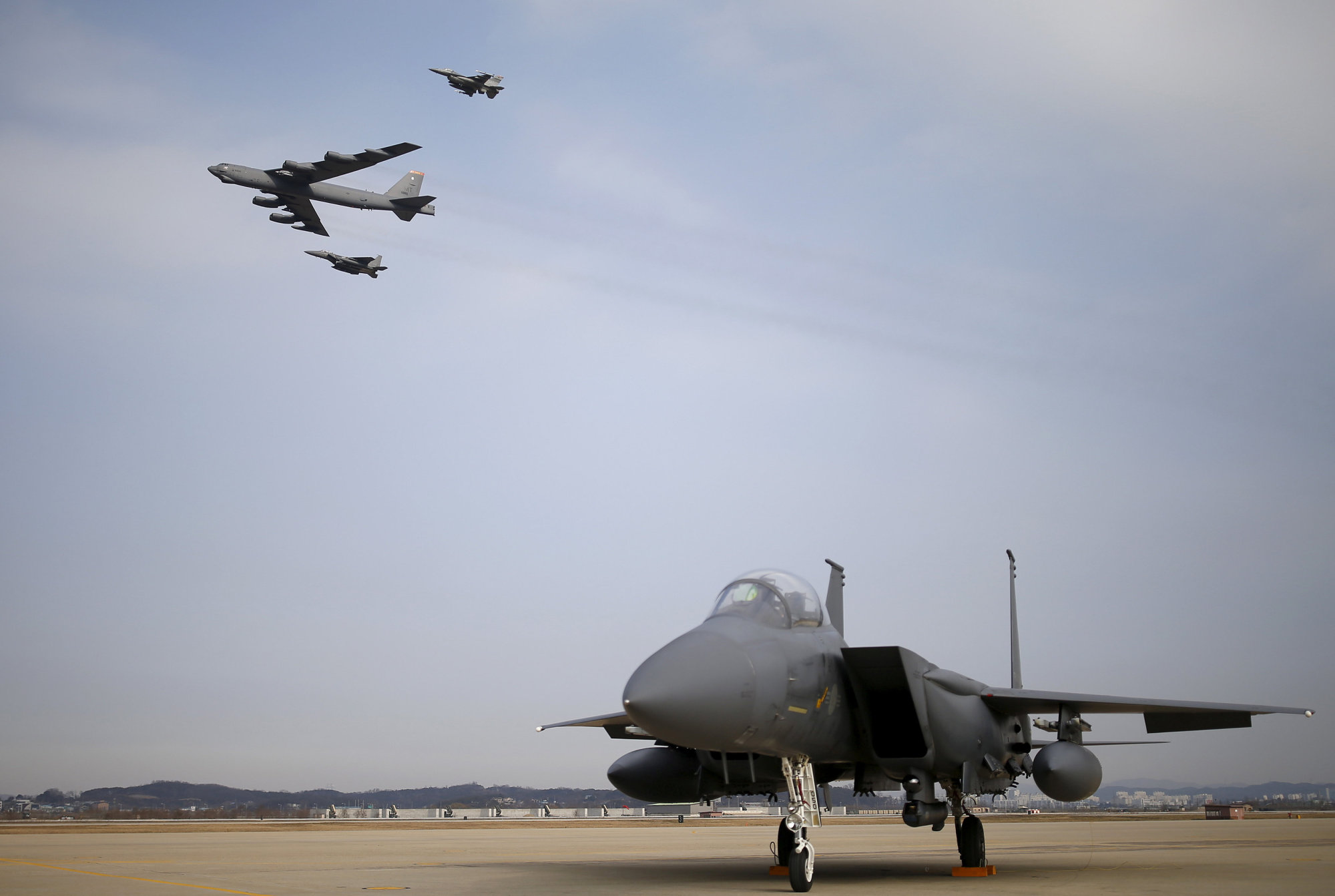 A U.S. Air Force B-52 flies over Osan Air Base in Pyeongtaek, South Korea, in January 2016. | REUTERS