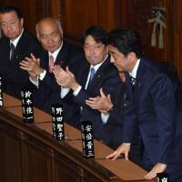Prime Minister Shinzo Abe receives applause at the Lower House on Wednesday as he is re-elected following the ruling bloc\'s landslide victory in last month\'s general election. | SATOKO KAWASAKI