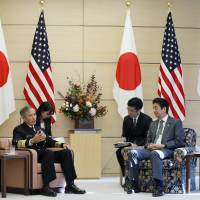 Prime Minister Shinzo Abe talks with Adm. Harry Harris (left), commander of U.S. Pacific Command, during a meeting at Abe\'s official residence in Tokyo on Thursday. | AP