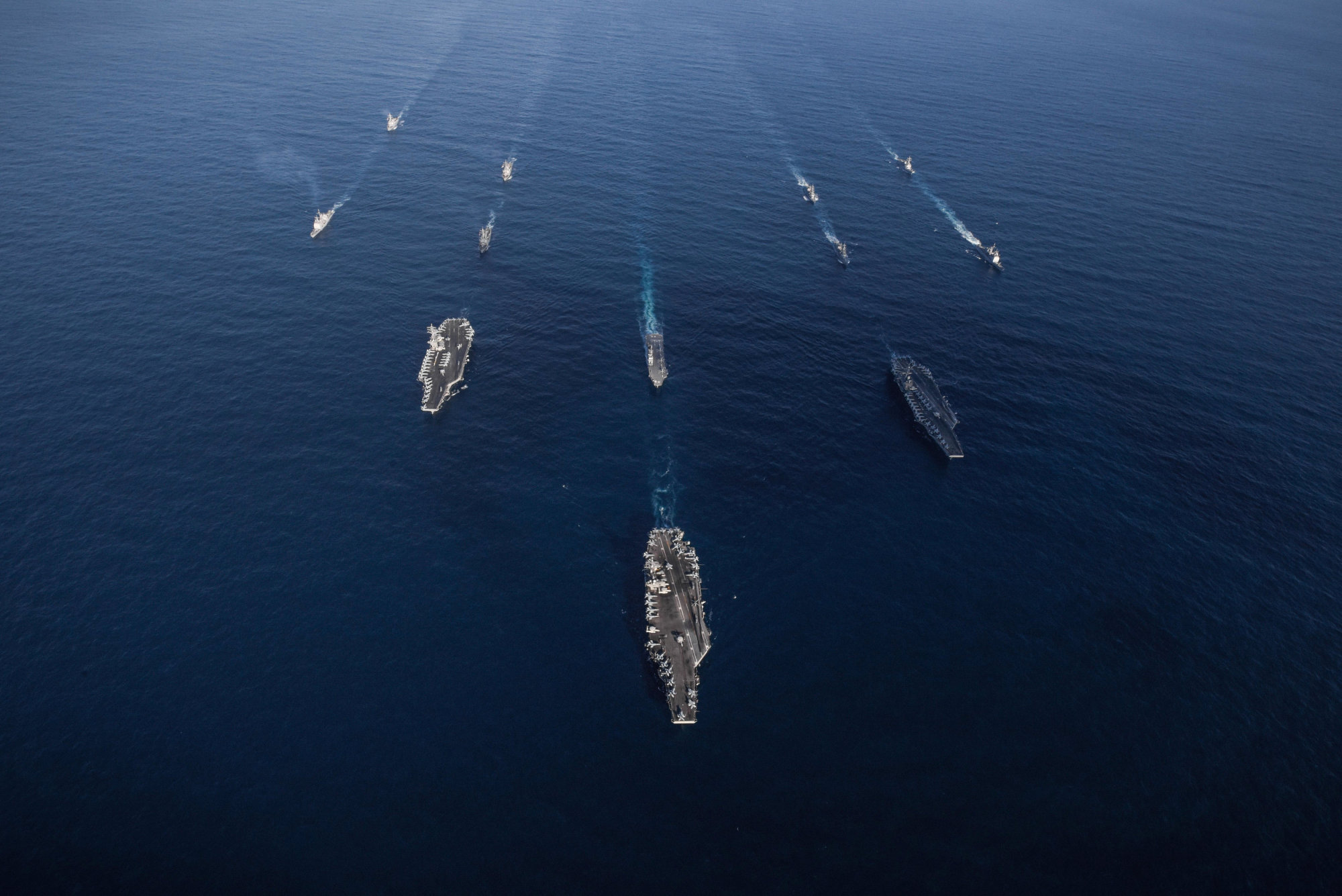 The USS Ronald Reagan, USS Theodore Roosevelt and USS Nimitz carrier strike groups transit the western Pacific Ocean with ships from the Maritime Self-Defense Force during operations in international waters as part of a three-carrier strike force exercise on Sunday. | U.S. NAVY / VIA REUTERS