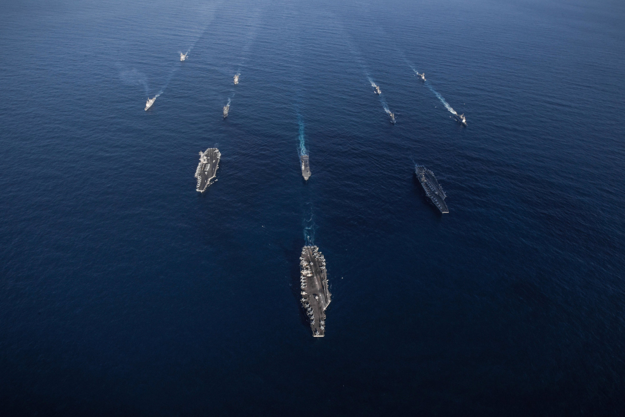 The USS Ronald Reagan, USS Theodore Roosevelt and USS Nimitz carrier strike groups transit the western Pacific Ocean with ships from the Maritime Self-Defense Force during operations in international waters as part of a three-carrier strike force exercise on Sunday. | U.S. NAVY / VIA REUTERS
