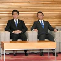 Prime Minister Shinzo Abe and his Cabinet ministers attend a meeting Tuesday at the Prime Minister\'s Office. | KYODO