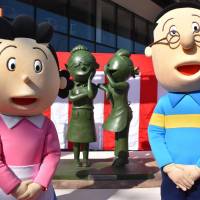 Bronze monuments of a popular cartoon character Sazae-san and its author, Machiko Hasegawa, are set up along a street in the city of Fukuoka in January. Sources said Toshiba Corp. is considering stopping being a sponsor of the long-running TV cartoon show. | KYODO