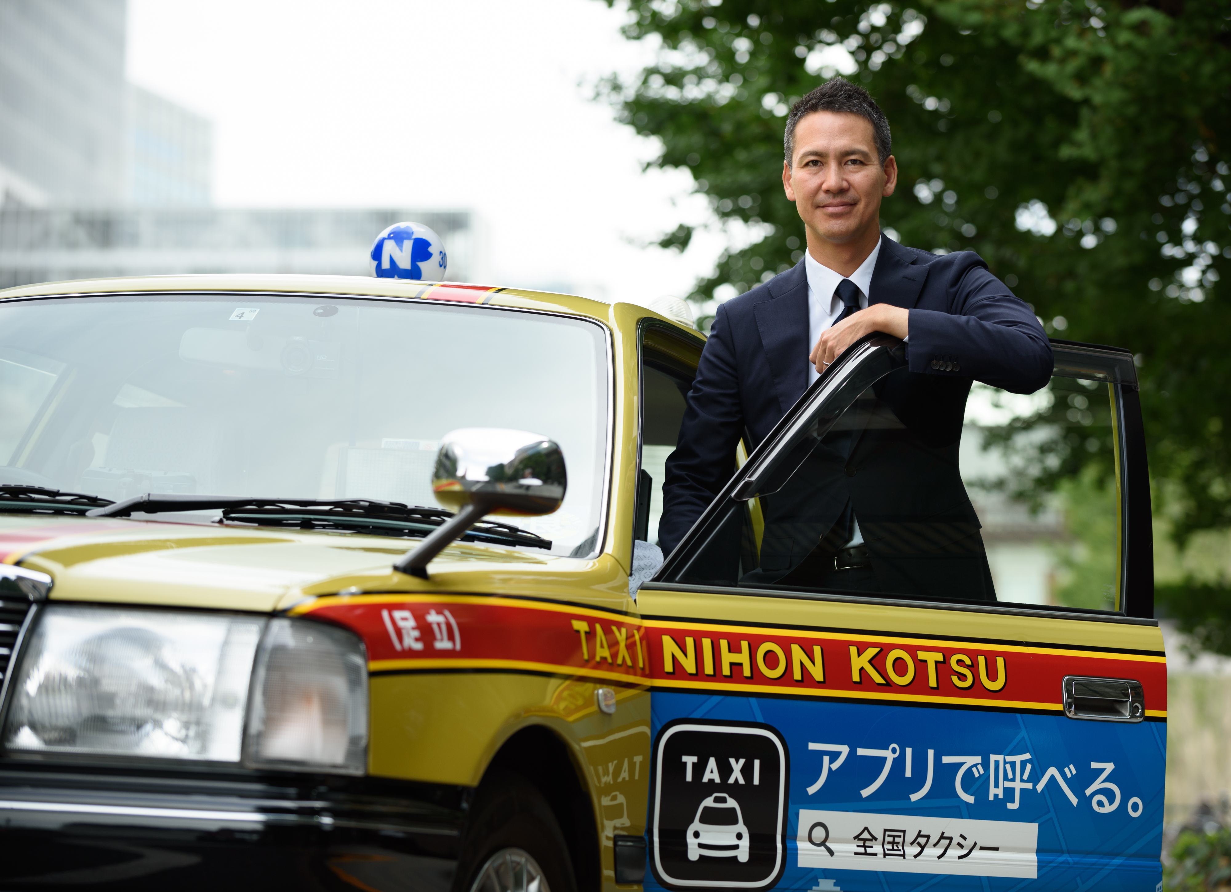 Ichiro Kawanabe, chairman of Nihon Kotsu Co., poses for a photograph in Tokyo on Sept. 15. Kawanabe is aiming to shake up his own ¥1.72 trillion ($15 billion) industry with a taxi-hailing app. He also plans to offer fixed-rate pricing and carpooling. | BLOOMBERG