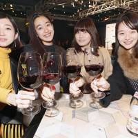 Women taste Beaujolais Nouveau in Tokyo\'s Shinjuku district, soon after the wine for 2017 was released after midnight Wednesday. | KYODO