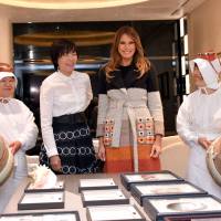 U.S. first lady Melania Trump is seen Prime Minister Shinzo Abe\'s wife, Akie, and two ama, traditionally trained female divers, during their visit to the main Mikimoto pearl shop in Tokyo\'s Ginza district on Sunday. | REUTERS