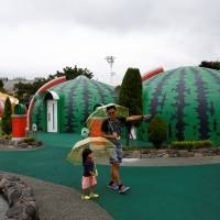 A family from Singapore takes a walk around quake-resistant dome houses. | REUTERS