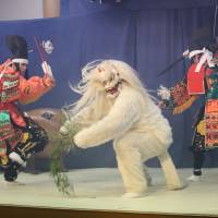 White devil: Members of the Kuwatatenshi Kagura Troupe take part in a scene depicting a battle between some warriors and a  white fox demon. | COURTESY OF AKITAKATA, HIROSHIMA PREFECTURE