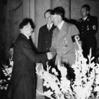 British Prime Minister Neville Chamberlain is greeted by Adolf Hitler in Germany before signing the Munich Agreement on Sept. 29, 1938. | BUNDESARCHIV
