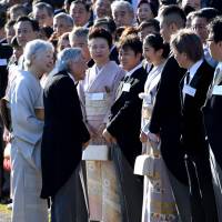 Chatting with the royals: The Imperial couple speak to guests at the autumn Imperial garden party at the Akasaka Imperial Garden in Tokyo. | AFP-JIJI