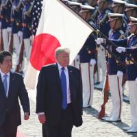 U.S. President Donald Trump reviews an honor guard with Prime Minister Shinzo Abe at Akasaka State Guest House in Tokyo on Monday. This year\'s annual Malabar exercise involving Japan, the U.S. and India was the largest so far. | AFP-JIJI