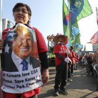 South Korean protesters against North Korea stage a rally in Seoul on Sunday to welcome U.S. President Donald Trump, who arrived in South Korea on Tuesday for a two-day visit. | AP