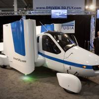 A Terrefugia flying car is displayed at the 2012 Auto Show in New York. Boston-based Terrafugia Inc, which plans to sell flying cars by 2019, has been acquired by Chinese automotive manufacturing company Geely. | BLOOMBERG