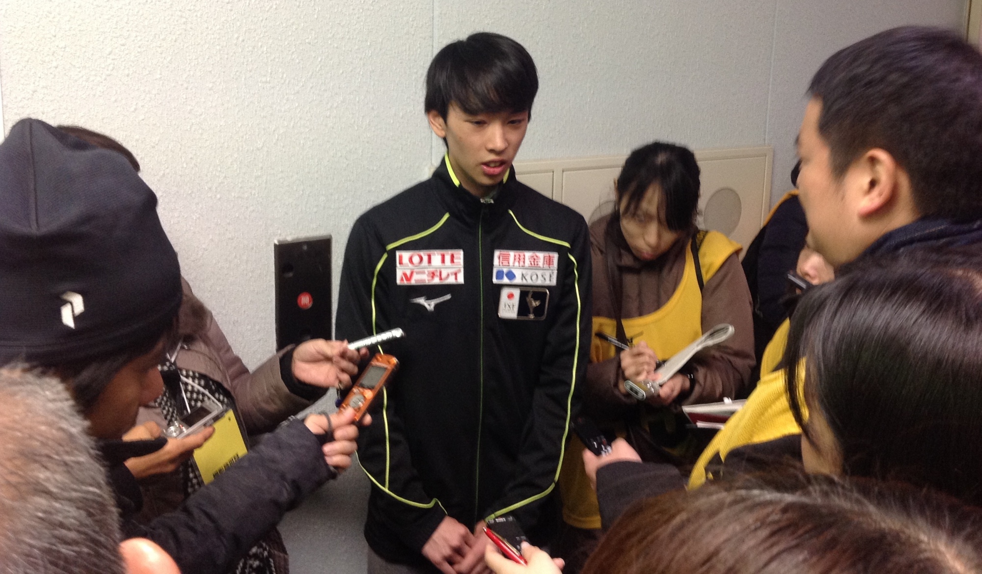 Mitsuki Sumoto talks to the media after his short program on Saturday. Sumoto is in first place with 67.34 points. | JACK GALLAGHER
