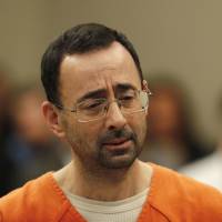 Dr. Larry Nassar appears in court for a plea hearing in Lansing, Michigan, Wednesday. Nasser, a sports doctor accused of molesting girls while working for USA Gymnastics and Michigan State University, pleaded guilty to multiple charges of sexual assault and will face at least 25 years in prison. | AP